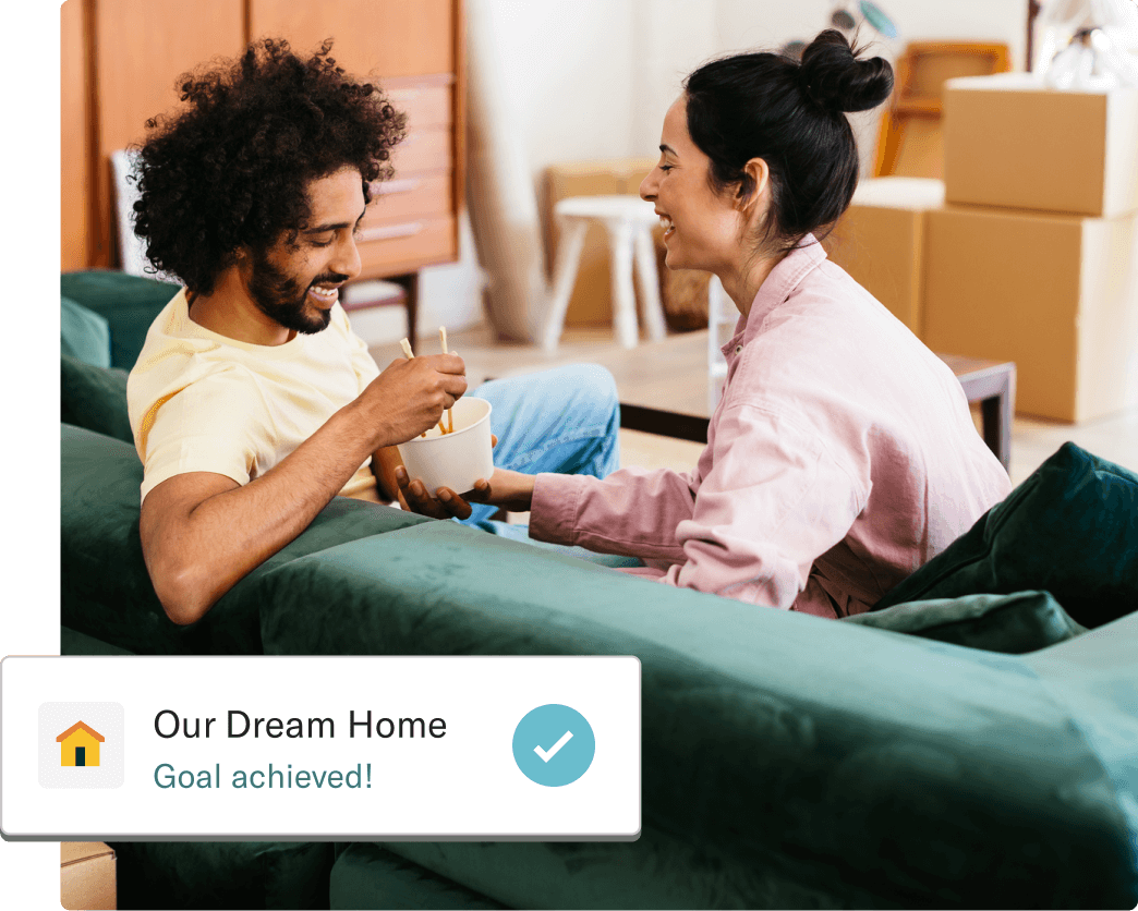 Two people celebrating in their newly purchased home next to a card showing our dream home goal achieved.